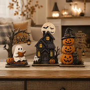Vintage Halloween resin décor set styled on a table near a fireplace