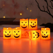 Atmospheric Halloween LED pumpkin candles glowing on marble surface