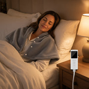 USA woman in bed — exact packing heating shawl, white LCD remote on nightstand
