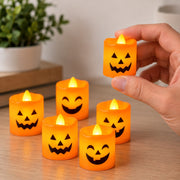 Hand holding flameless Halloween LED pumpkin candle for scale